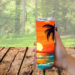 This photo shows a woman holding the beach sunset tumbler outdoors with trees in the background. Perfect for your travels, beach, camping
